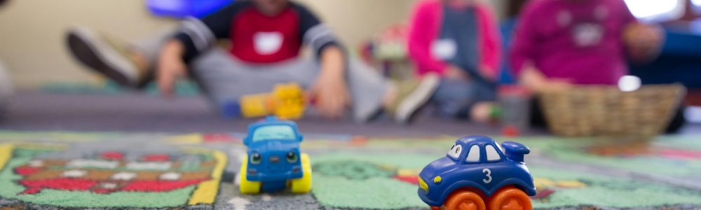 a group of children playing with toys on the floor